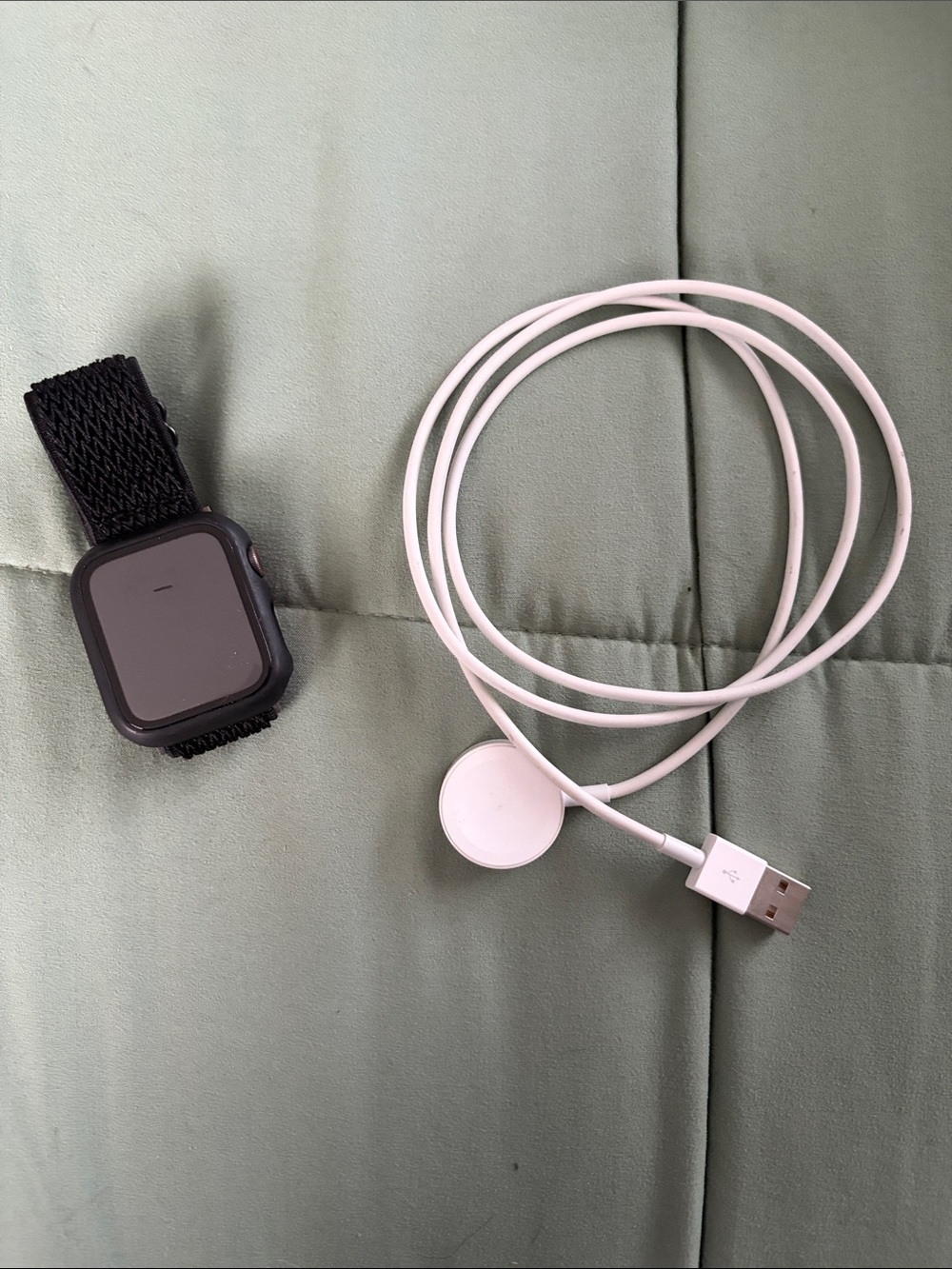 Apple Black Smartwatch with Black Nylon Loop Band and White Charger Cable